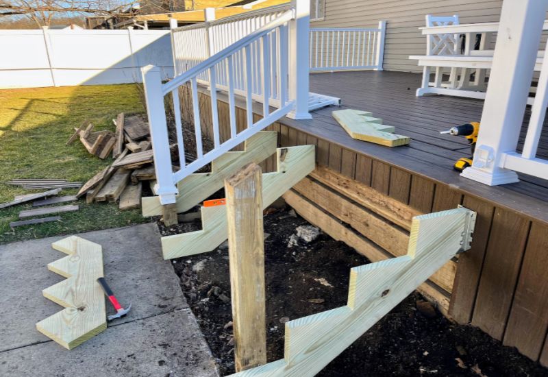 Five Star Deck Service experts fixing stairs to the deck in Annapolis, MD